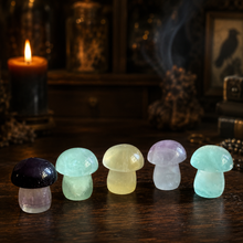 Load image into Gallery viewer, Five candy fluorite mushroom crystal carvings in green, yellow, lavender and purple on a dark collector's study table