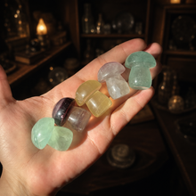 Load image into Gallery viewer, Seven mini candy fluorite mushroom carvings held in a hand for scale