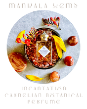 Load image into Gallery viewer, Perfume bottle with botanical elements on a textured surface, featuring the brand 'Mandala Gems'.