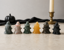 Load image into Gallery viewer, Six crystal ghosts wearing witch hats standing in a Halloween tabletop setting
