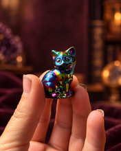 Load image into Gallery viewer, One rainbow aura cat carving held between fingers for size reference
