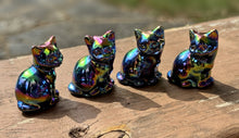 Load image into Gallery viewer, Four real rainbow aura cat carvings on a weathered wood surface; colors vary by piece
