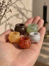 Load image into Gallery viewer, Five assorted 3 cm crystal cauldrons held in a palm
