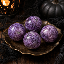 Load image into Gallery viewer, Polished charoite spheres in a Halloween collector's study
