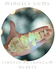 Load image into Gallery viewer, Hand holding firefly petroleum quarts with 'Manala Gems' branding.
