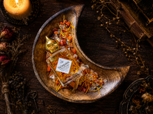 Load image into Gallery viewer, Incantation carnelian botanical perfume oil in a Halloween collector's study
