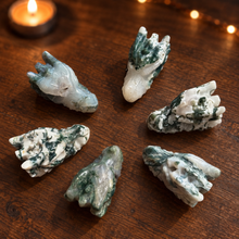 Load image into Gallery viewer, Six moss agate dragon head carvings showing natural stone variation on dark wood
