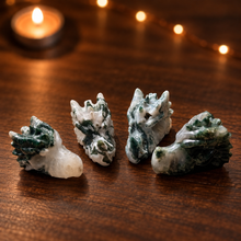 Load image into Gallery viewer, Four moss agate dragon head carvings arranged on dark wood
