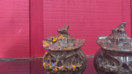 Muted video showing Yooperlite pumpkin carvings under UV light