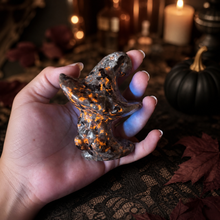 Load image into Gallery viewer, Hand holding a glowing Yooperlite ghost witch hat carving with spooky Halloween decor
