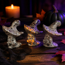 Load image into Gallery viewer, Three Yooperlite ghost witch hat carvings in a moody Halloween scene
